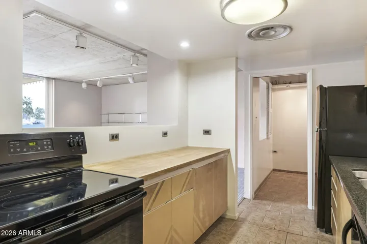 Kitchen with signature mid-century pass-through window opening to the light-filled living space.