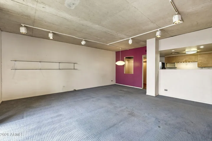 Open living space with exposed concrete ceilings.