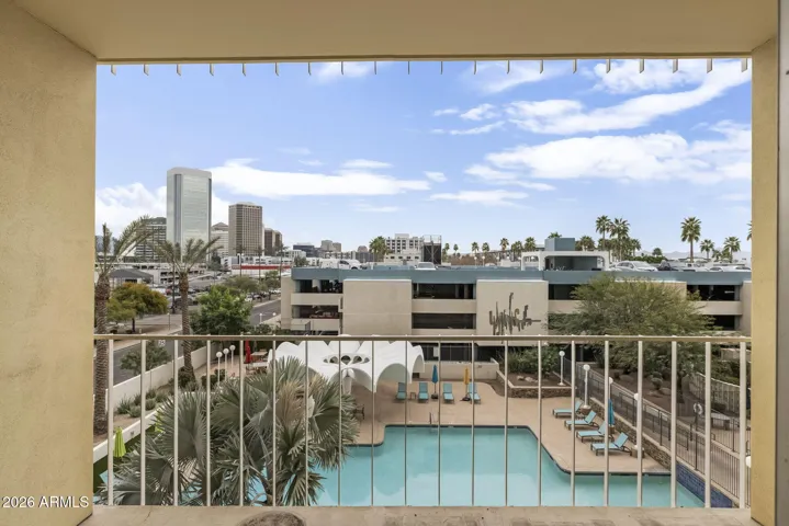 Private balcony overlooking the heated pool and iconic architectural canopy.