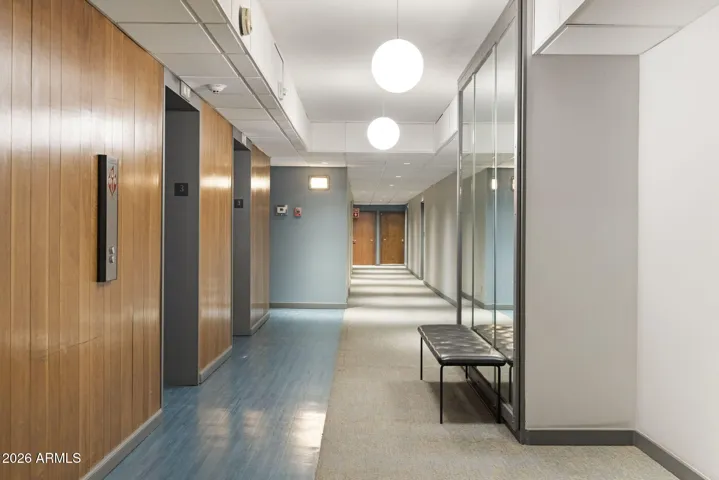 Clean, secured corridor with elevator access serving the building.