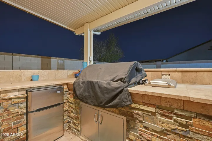 Built in BBQ area with built in grill and mini fridge
