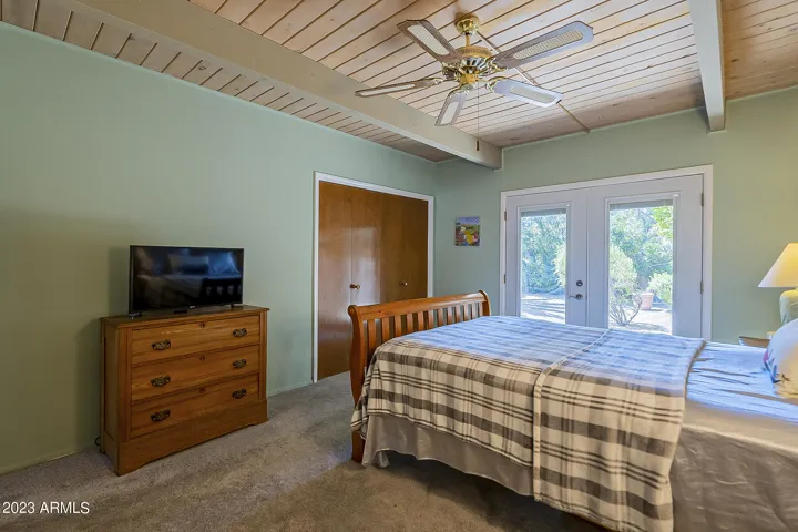 Primary Bedroom with doors to backyard