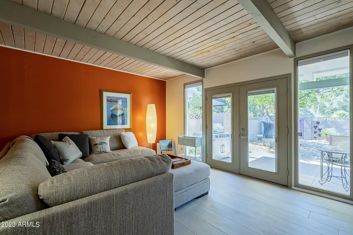 Great Room with original wood and beam ceilings, updated French doors leading out to backyard