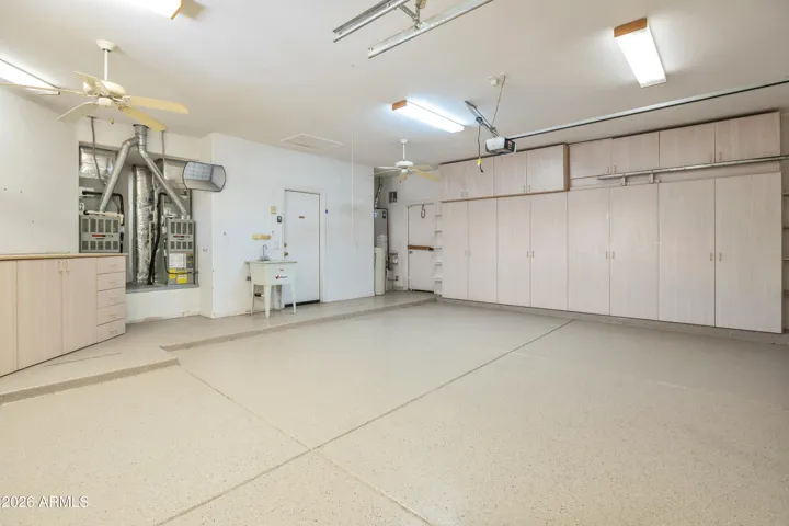 Garage With Extensive Built In Cabinetry