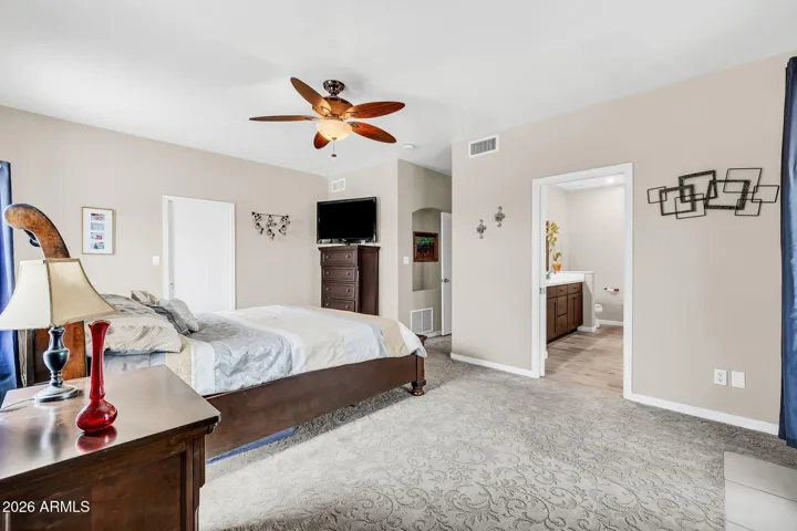 Upstairs Primary bedroom with walk-in closet and balcony