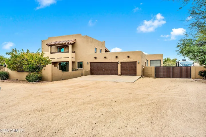 Front of home with attached garage and RV gate
