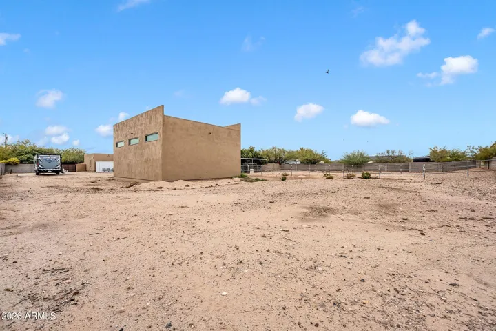 View from very back of yard on southeast side looking at RV garage and horse stalls