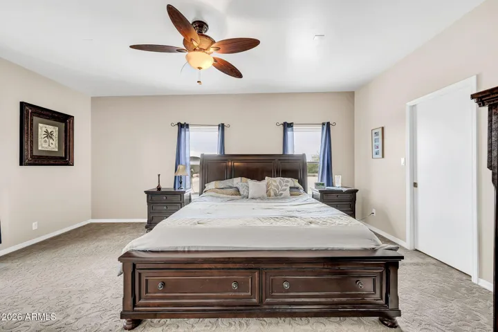 Upstairs Primary bedroom with walk-in closet and balcony
