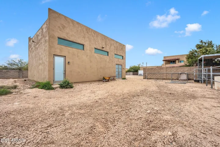 Side of RV garage and partial horse stalls