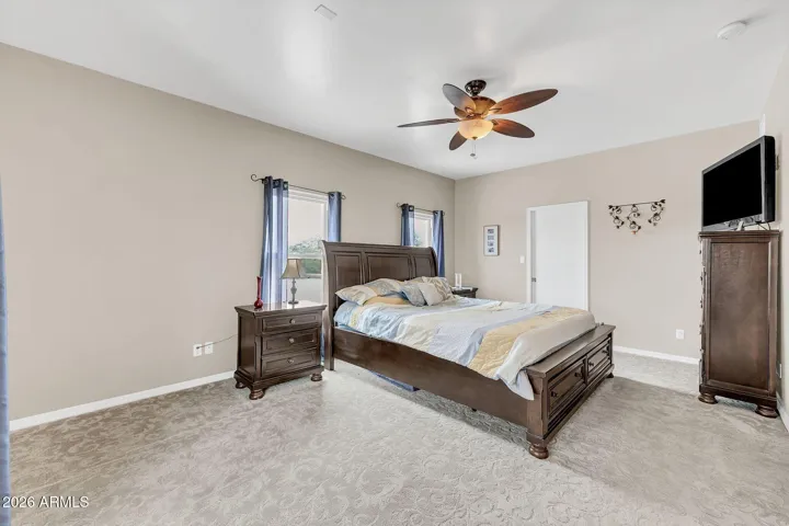Upstairs Primary bedroom with walk-in closet and balcony