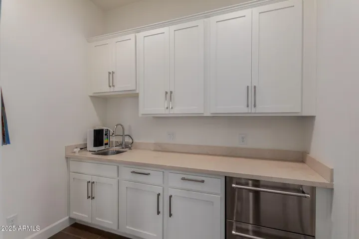 Casita kitchenette with fridge/freezer combo, extra cabinetry and kitchen sink