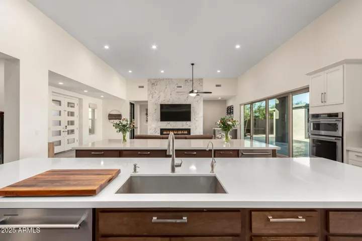 Chef's kitchen overlooking living room for entertaining