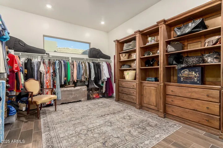 Spacious primary bedroom walk in closet with built in