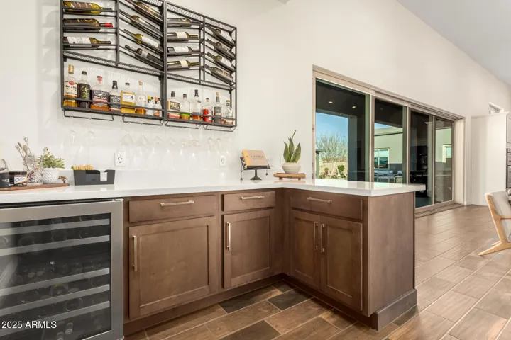 Indoor bar with sink and wine fridge