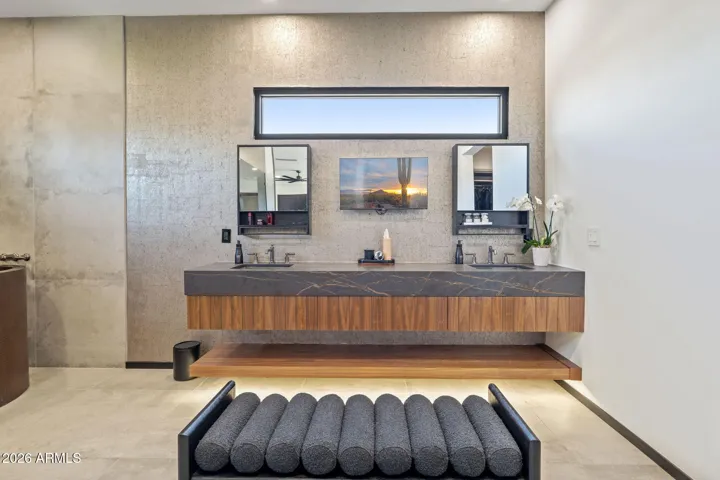 Duel sinks, custom cabinetry, and porcelain counters lend a luxury feel