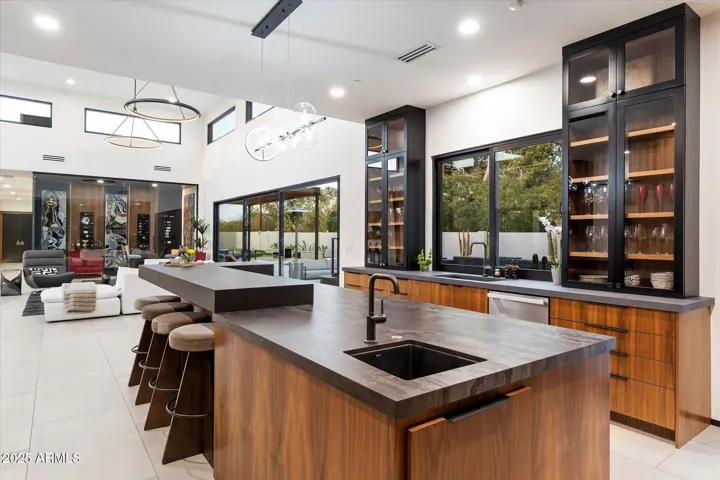 Miele appliances – refrigerator, gas range, double ovens, warming drawer, and built-in coffee machine.
