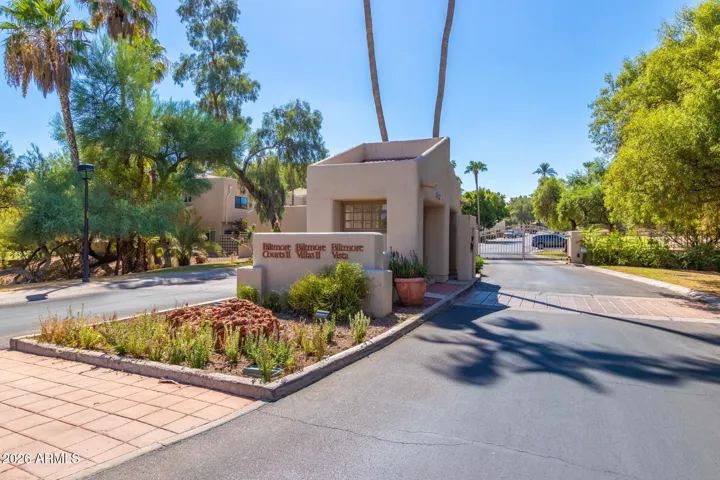 Welcoming community entrance with maintained landscaping and access drive.