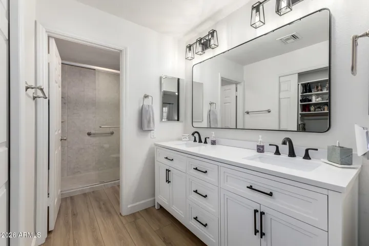 Primary bathroom featuring dual sink vanity, modern fixtures, and generous counter space.