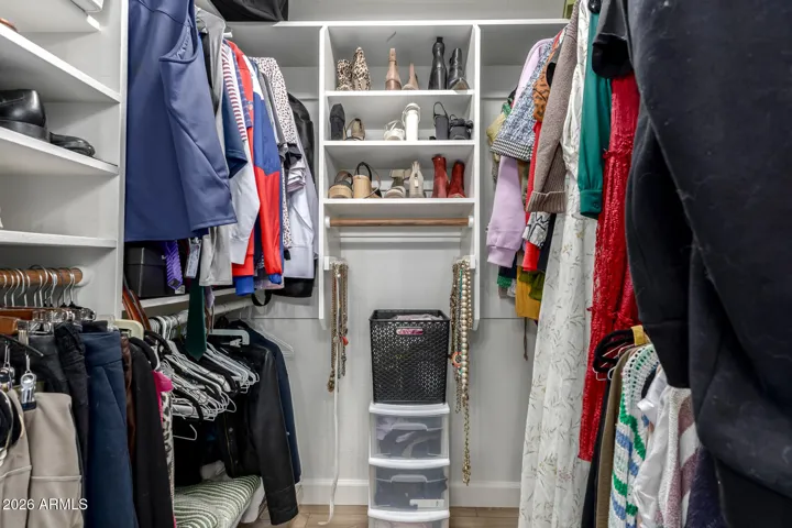 Walk-in closet with built-in shelving and hanging space for organized storage.