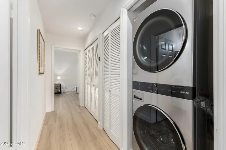Convenient in-unit laundry area with stacked washer and dryer.