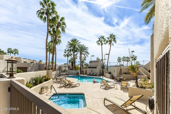 Community swimming pool with lounge seating and landscaped surroundings.