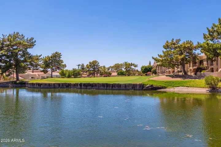 Scenic community lake surrounded by landscaped grounds and walking areas.