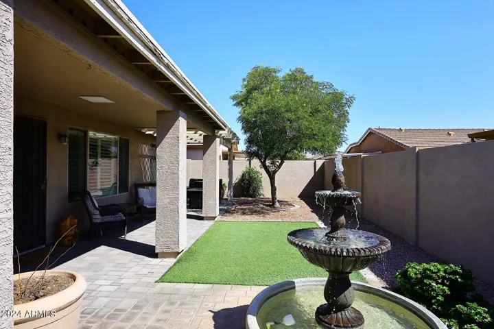 Synthetic grass, fountain and extended patio