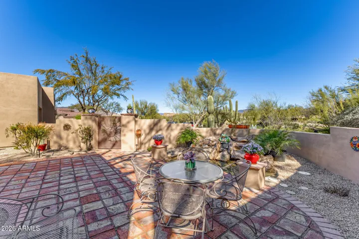 Gated entry with fountain and mountain views
