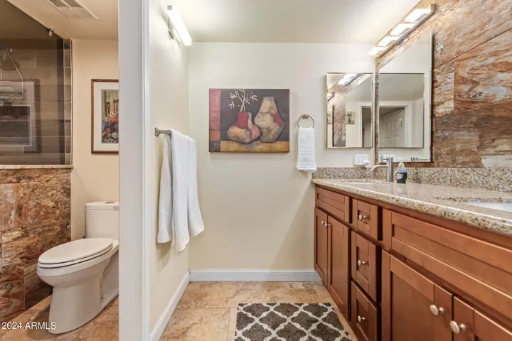 Remodeled bathroom with upgraded maple cabinets, tile and granite.