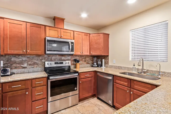 Remodeled kitchen with granite countertops, stainless steel appliances (owner removed soffit to increase ceiling height and light to kitchen)