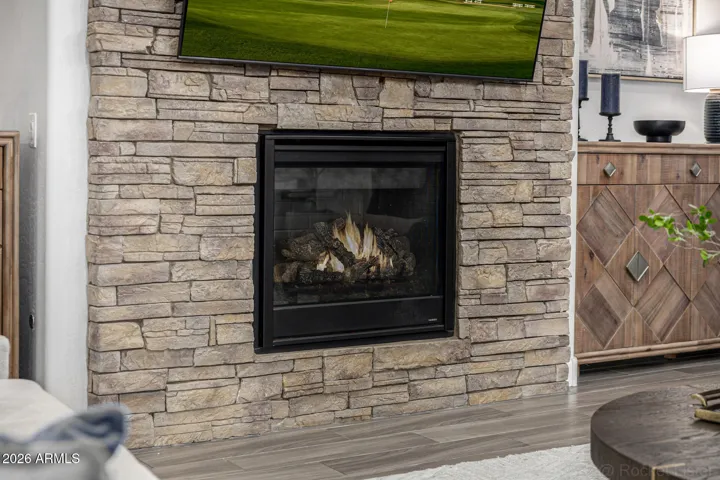 The striking stacked-stone gas fireplace creates a beautiful focal point in the great room; perfect for cozy evenings and relaxed gatherings.