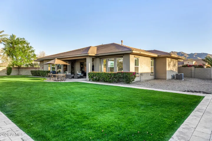 Professionally designed landscaping, extensive low-voltage lighting, and multiple outdoor living areas for front and back...