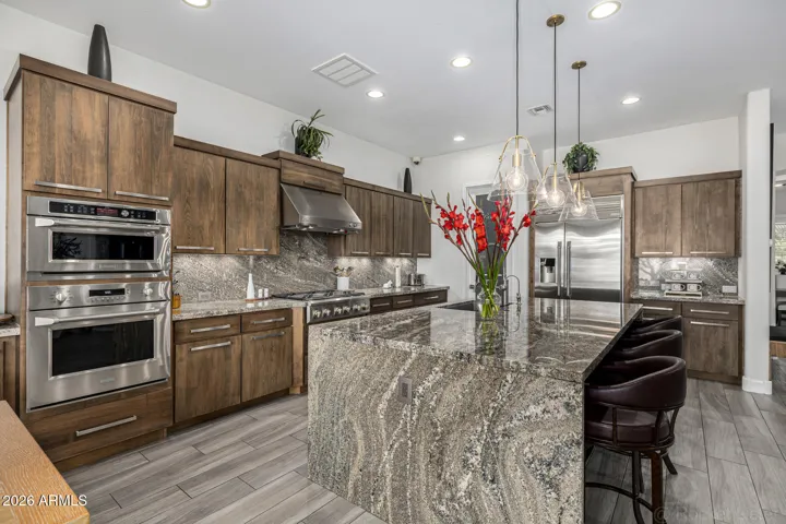 Timeless finishes, professional-grade appliances, and thoughtful craftsmanship create a kitchen that feels both elevated and inviting.