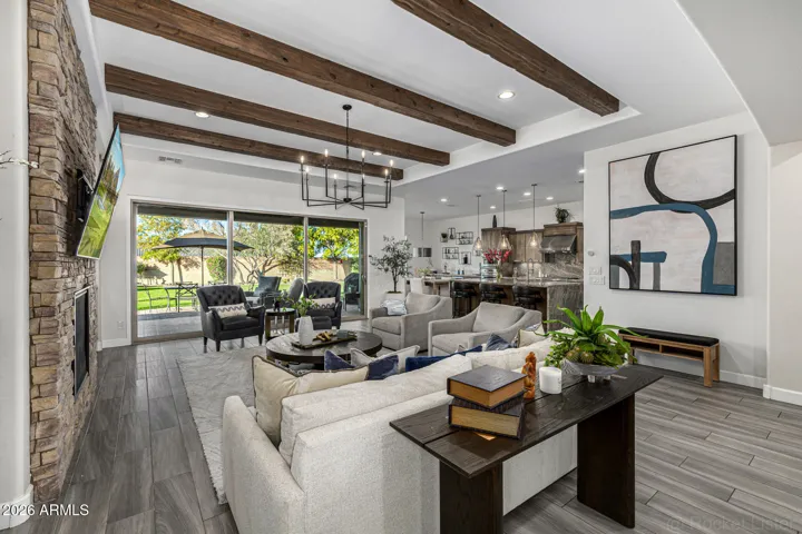 The grand living room extends naturally to the patio, creating a beautiful setting for entertaining, sunset cocktails, and evenings under the desert sky.