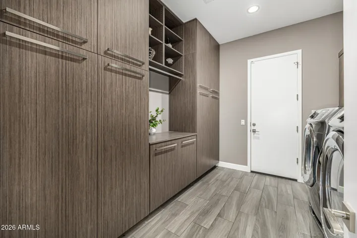 Spacious laundry room with Alder wood cabinets, upgraded hardware...