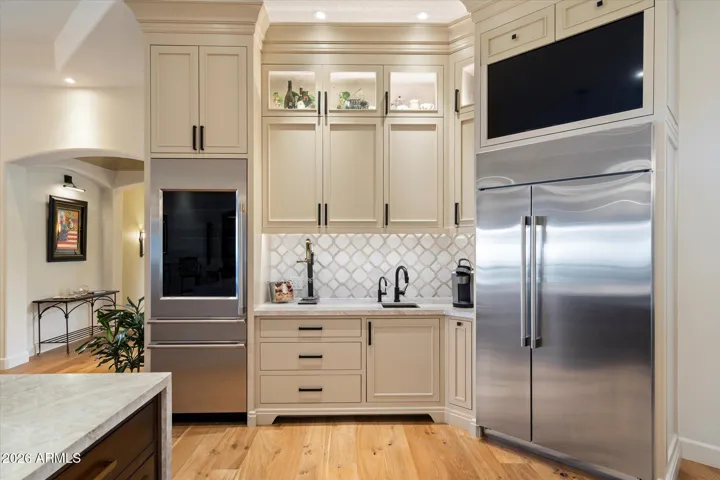 Wine fridge tower, custom coffee bar & pod drawers.
