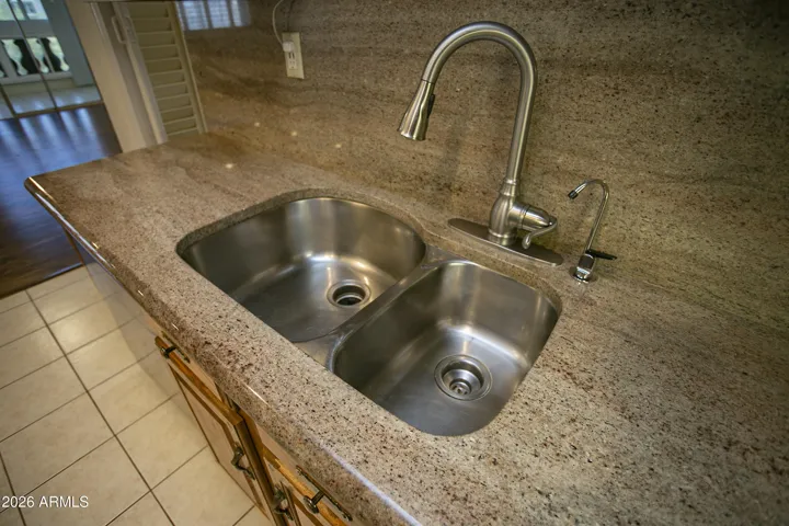Double sinks, full granite counter and backsplash.
