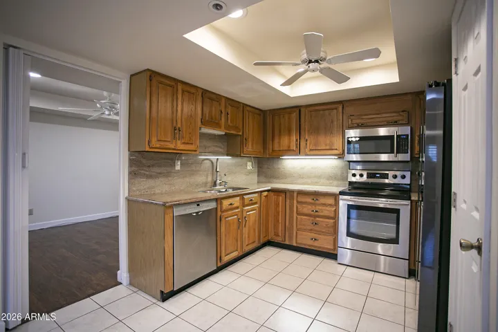 Kitchen is equipped with SS appliances and a full pantry with slid-out shelving.