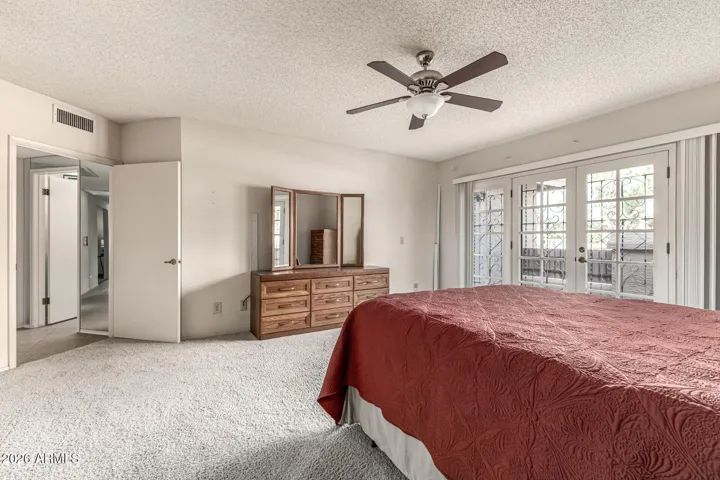 primary suite w/private French door access to the front yard
