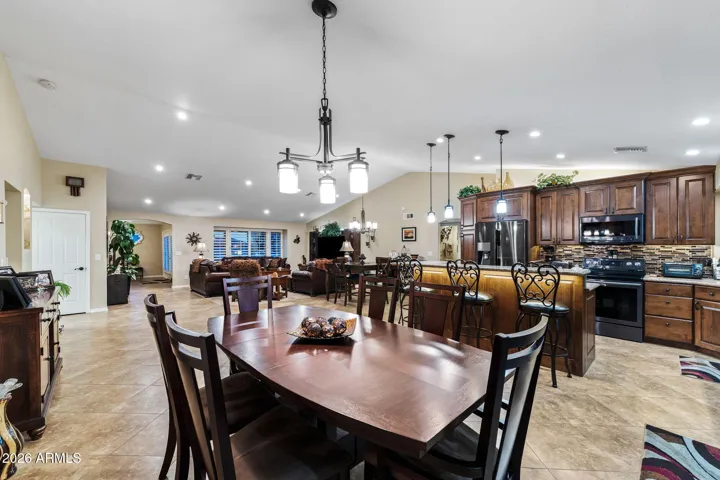The large kitchen eating area looks to the kitchen and has access and views to the golf course.