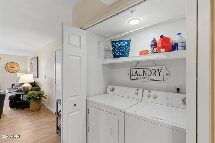 Clean laundry room with ample shelving