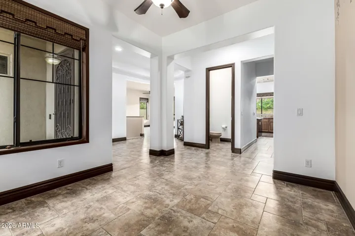 Open-concept entry with clear sightlines into main living areas, featuring tile flooring and upgraded trim. This Goodyear home offers a functional and inviting layout designed for modern living.