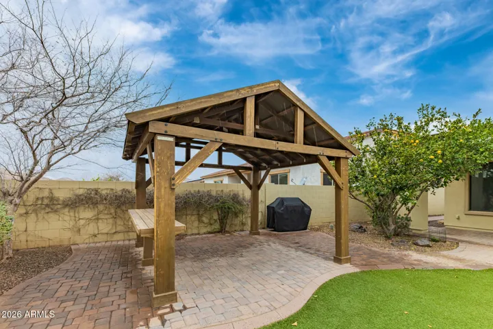 Charming pergola area in Goodyear with built-in seating and paver flooring. Ideal for outdoor dining or relaxing in a shaded, private backyard setting.