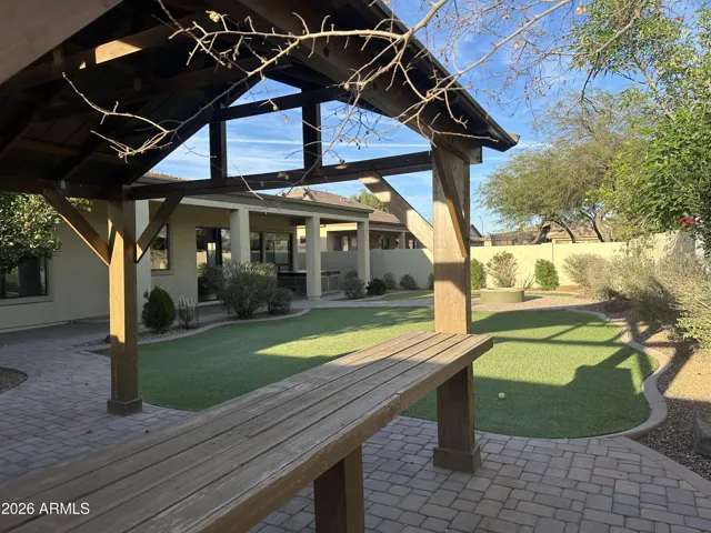 Backyard pergola in Goodyear offering shaded seating and scenic views of turf and landscaping. A perfect space for hosting guests or enjoying peaceful outdoor moments.