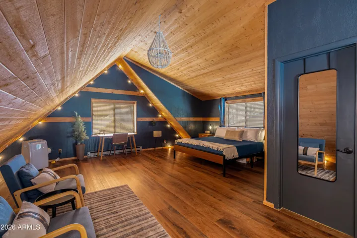 Spacious Primary Suite/Loft with NEW flooring, peaked ceilings, NEW paint, and en-suite bathroom.