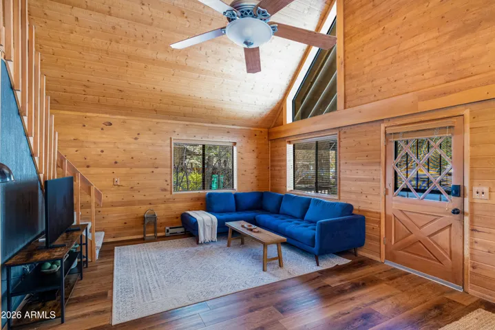 Peaked ceilings with ample natural light, NEW flooring, NEW interior paint, and NEW stove/fireplace.