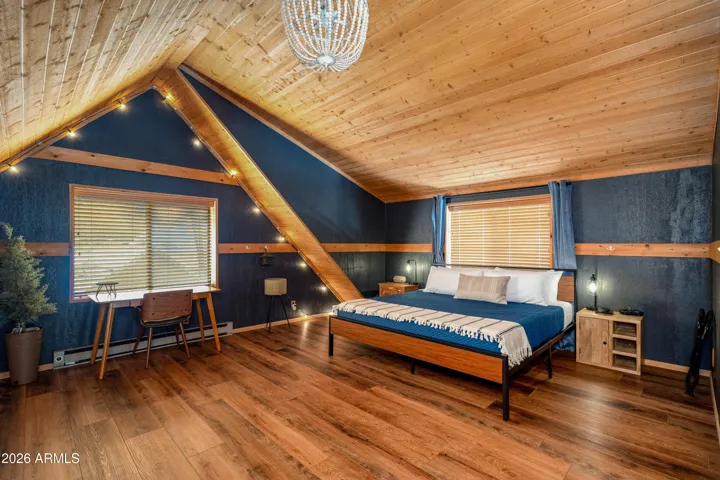 Spacious Primary Suite/Loft with NEW flooring, peaked ceilings, NEW paint, and en-suite bathroom.