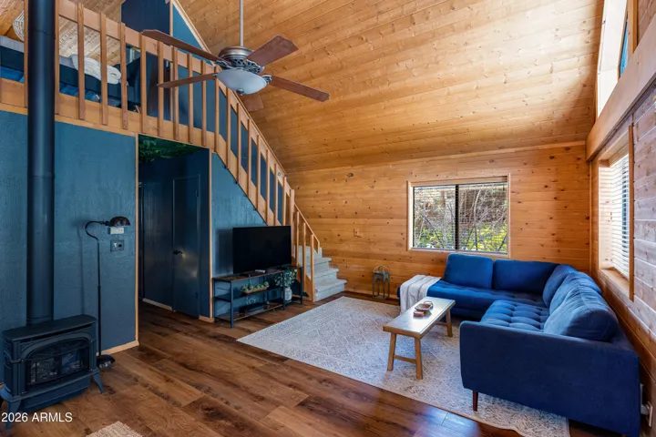 Peaked ceilings with ample natural light, NEW flooring, NEW interior paint, and NEW stove/fireplace.