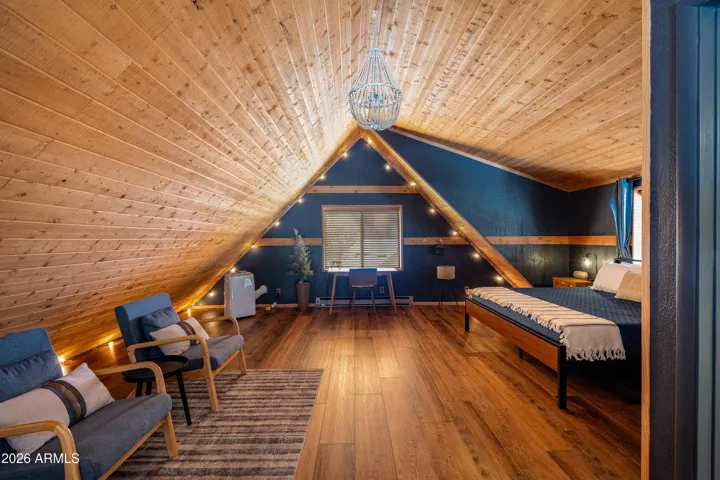 Spacious Primary Suite/Loft with NEW flooring, peaked ceilings, NEW paint, and en-suite bathroom.