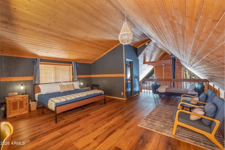 Spacious Primary Suite/Loft with NEW flooring, peaked ceilings, NEW paint, and en-suite bathroom.